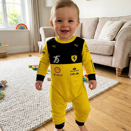 Baby wearing Ferrari 75 Years onesie jumpsuit smiling in living room, yellow and black F1 race suit