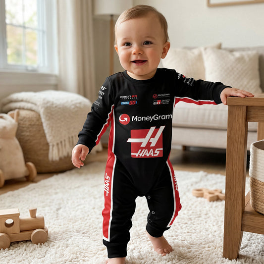 Baby standing in Haas 2025 F1 racing onesie smiling in living room with wooden toys