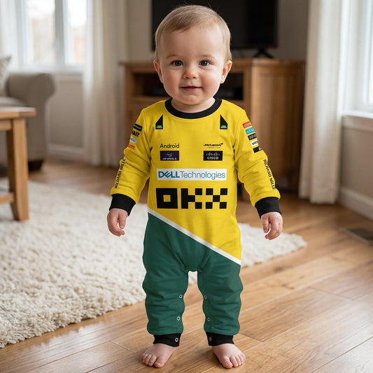 Toddler standing in living room wearing yellow green McLaren Senna F1 baby onesie jumpsuit with sponsor logos