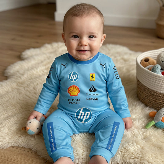 Smiling baby on a white rug wearing a light blue Ferrari F1 racing suit onesie with sponsor logos and prancing horse shield