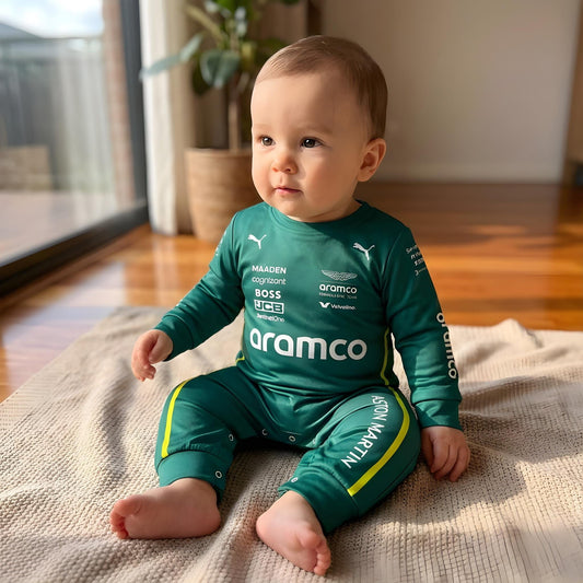 baby sitting down wearing aston martin jumpsuit