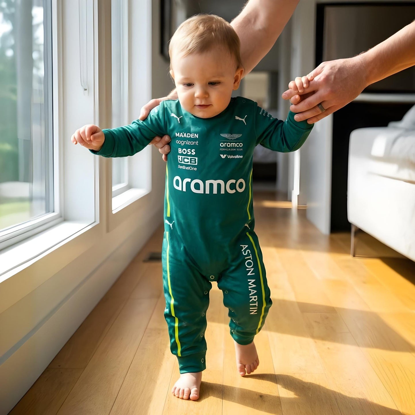 toddler taking first steps wearing aston martin baby romper