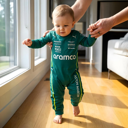 toddler taking first steps wearing aston martin baby romper