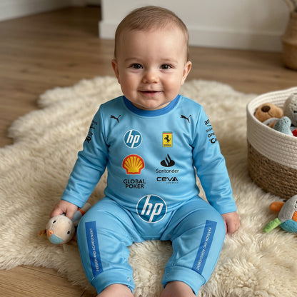 Baby sitting on rug in nursery wearing Ferrari blue special edition F1 onesie jumpsuit with plush toy