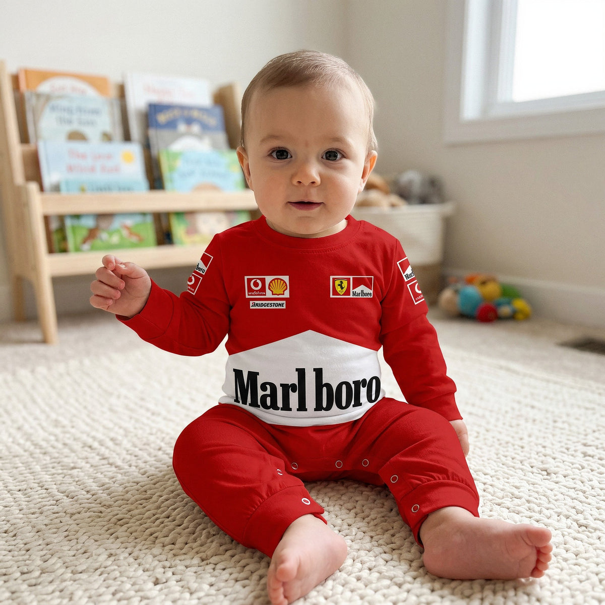 Baby sitting on rug in nursery wearing red Ferrari Marlboro racing onesie jumpsuit with white band