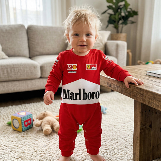 Toddler wearing red Ferrari Marlboro racing onesie standing in living room with Ferrari and Shell logos