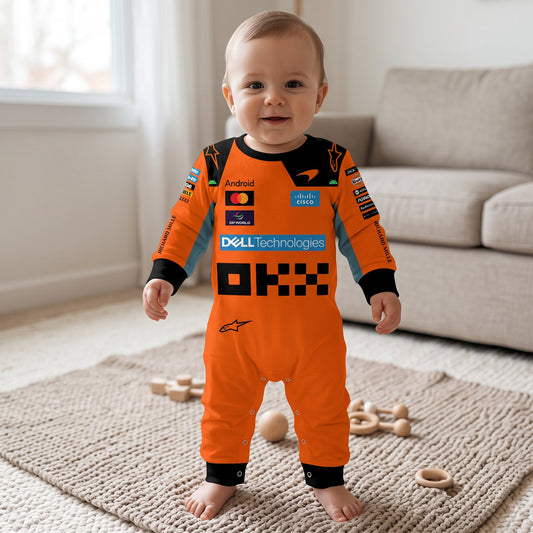 Baby wearing McLaren 2026 racing onesie jumpsuit standing in living room with orange OKX Dell team design