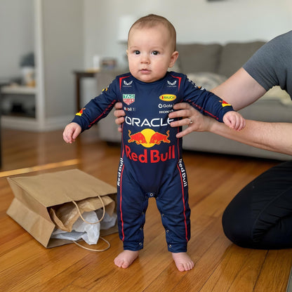 toddler taking first steps in Red Bull Racing bodysuit