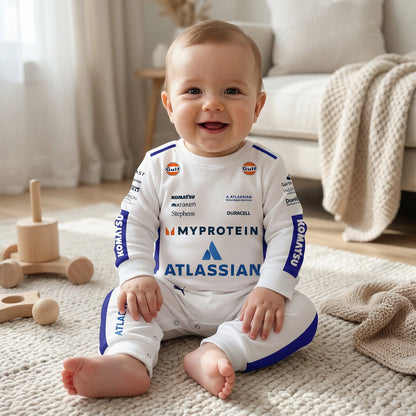Baby sitting wearing Williams 2025 F1 jumpsuit onesie laughing with wooden toys and racing sponsor logos
