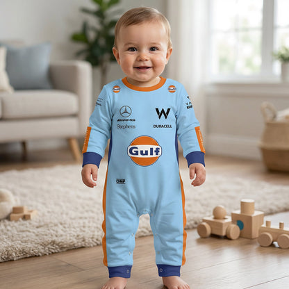 Baby wearing Williams Gulf special edition racing onesie jumpsuit standing and smiling in living room